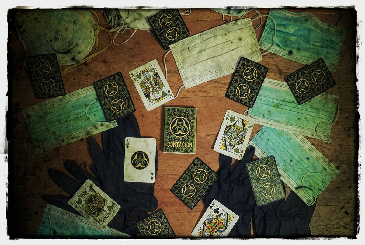 Contagion Playing Cards by Bill Davis Magic – Custom green and black virus-themed playing cards displayed with surgical masks and protective gloves, showing unique court cards and biohazard artwork.