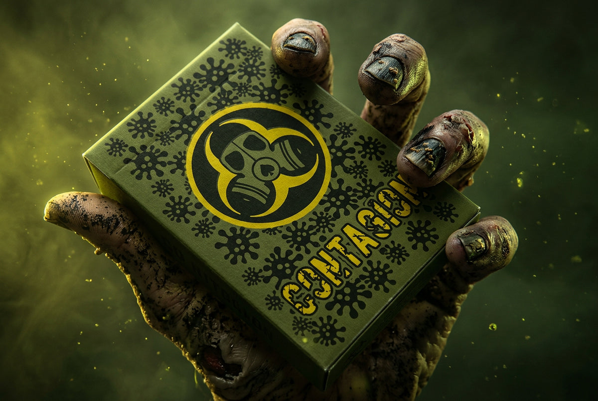 Contagion Playing Cards by Bill Davis Magic – Green virus-themed tuck box featuring a yellow gas mask symbol, held in a zombie-style hand against a dark green background.