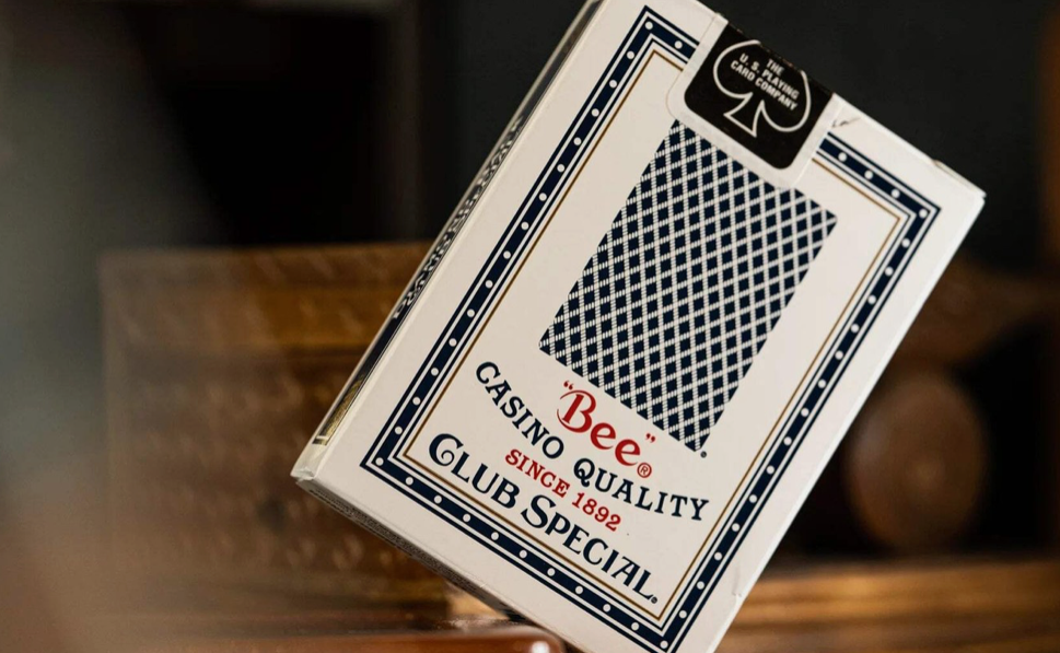 Angled rear view of Bee Club Special Standard Index Blue Playing Cards showing the classic blue diamond-back design, casino-quality packaging and USPCC seal.