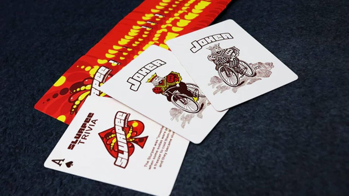 Bicycle Slurpee 7-Eleven Playing Cards showing two custom illustrated Joker cards, Slurpee-themed Ace of Spades and colourful red and yellow card back.