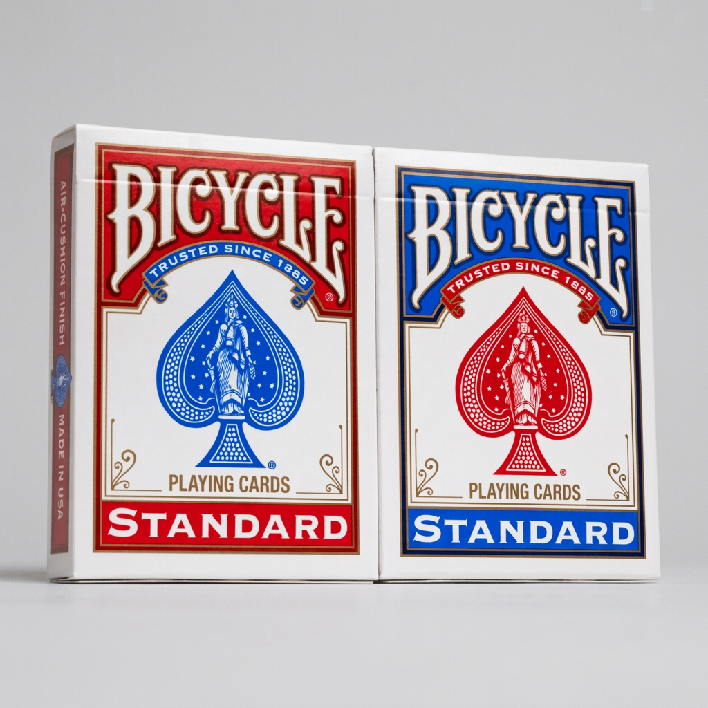 Red and blue Bicycle Standard playing card tuck boxes standing side by side on a light background.