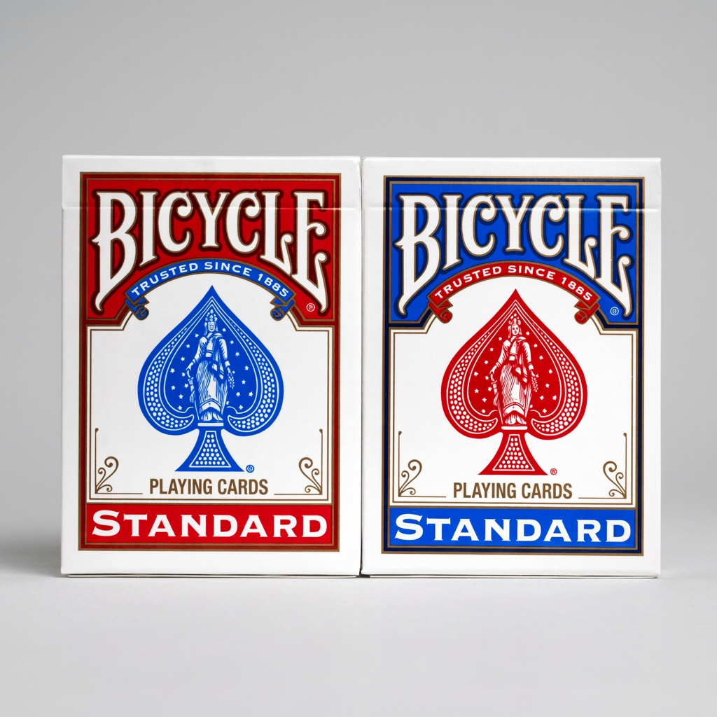 Front view of red and blue Bicycle Standard playing card tuck boxes side by side on a light grey background.