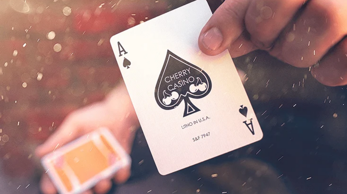 Close-up of the custom Ace of Spades from Cherry Casino Summerlin Sunset Orange Playing Cards, featuring the black Cherry Casino spade emblem and cherry artwork.