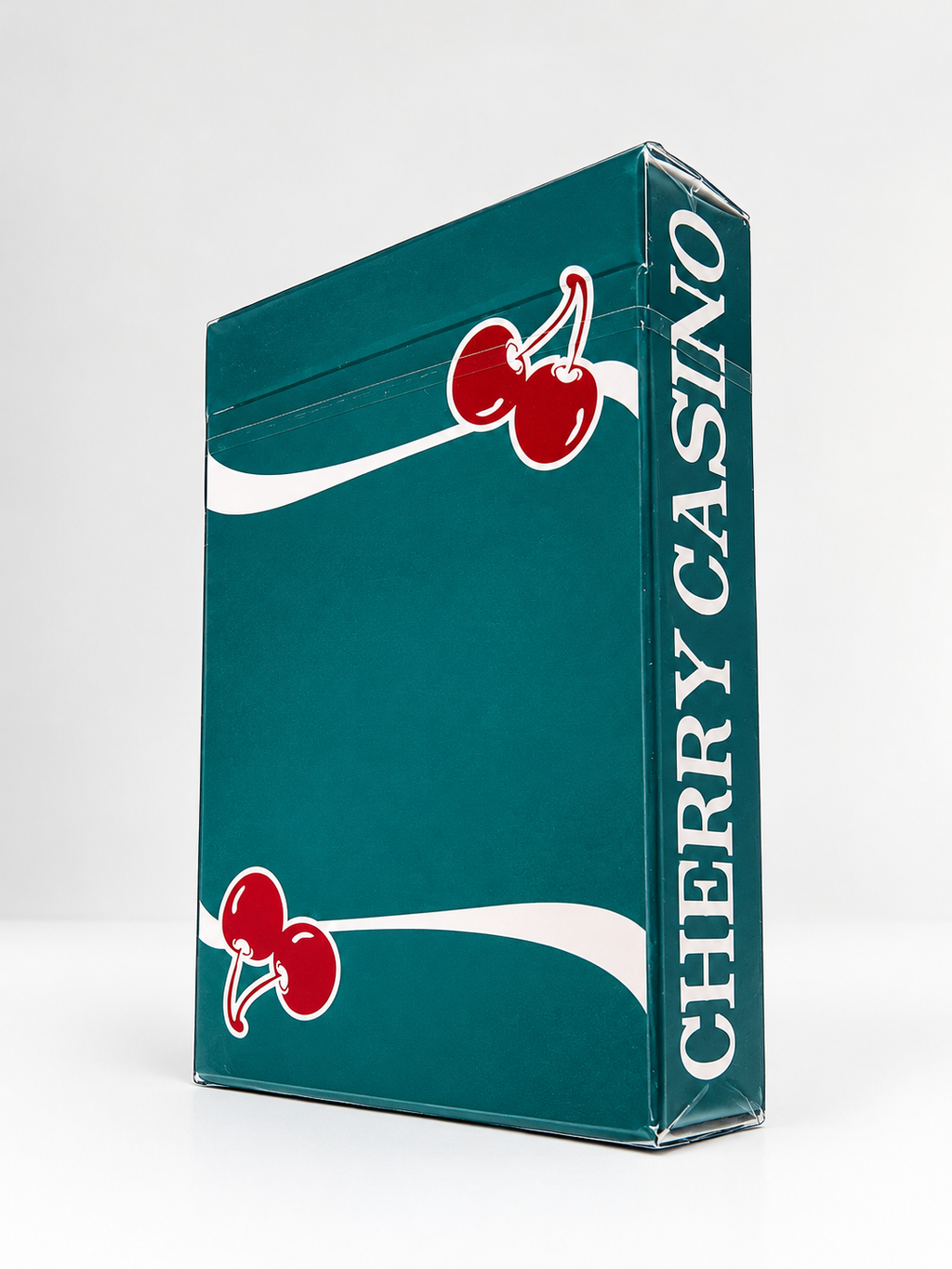Angled view of Cherry Casino Tropicana Teal Playing Cards showing the teal tuck box, red cherry artwork, white stripes and Cherry Casino lettering along the side.