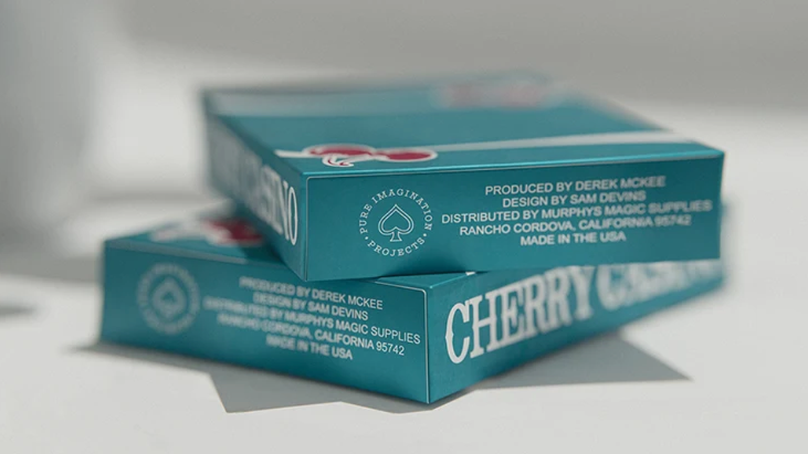 Two Cherry Casino Tropicana Teal playing card decks stacked together, showing the teal tuck boxes, Cherry Casino lettering and Pure Imagination Projects branding.