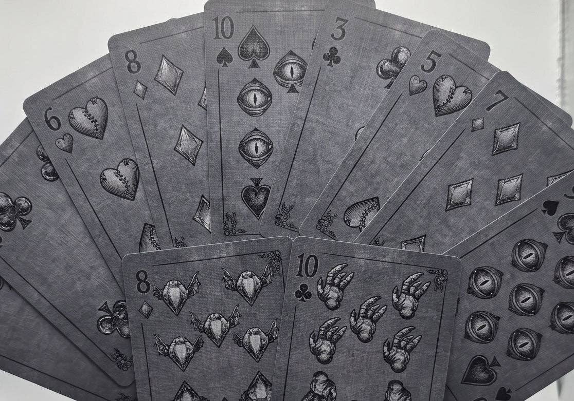 Classic Monsters Playing Cards by Collectible Playing Cards showing custom number cards with stitched hearts, monster eyes, claws and gothic suit symbols.