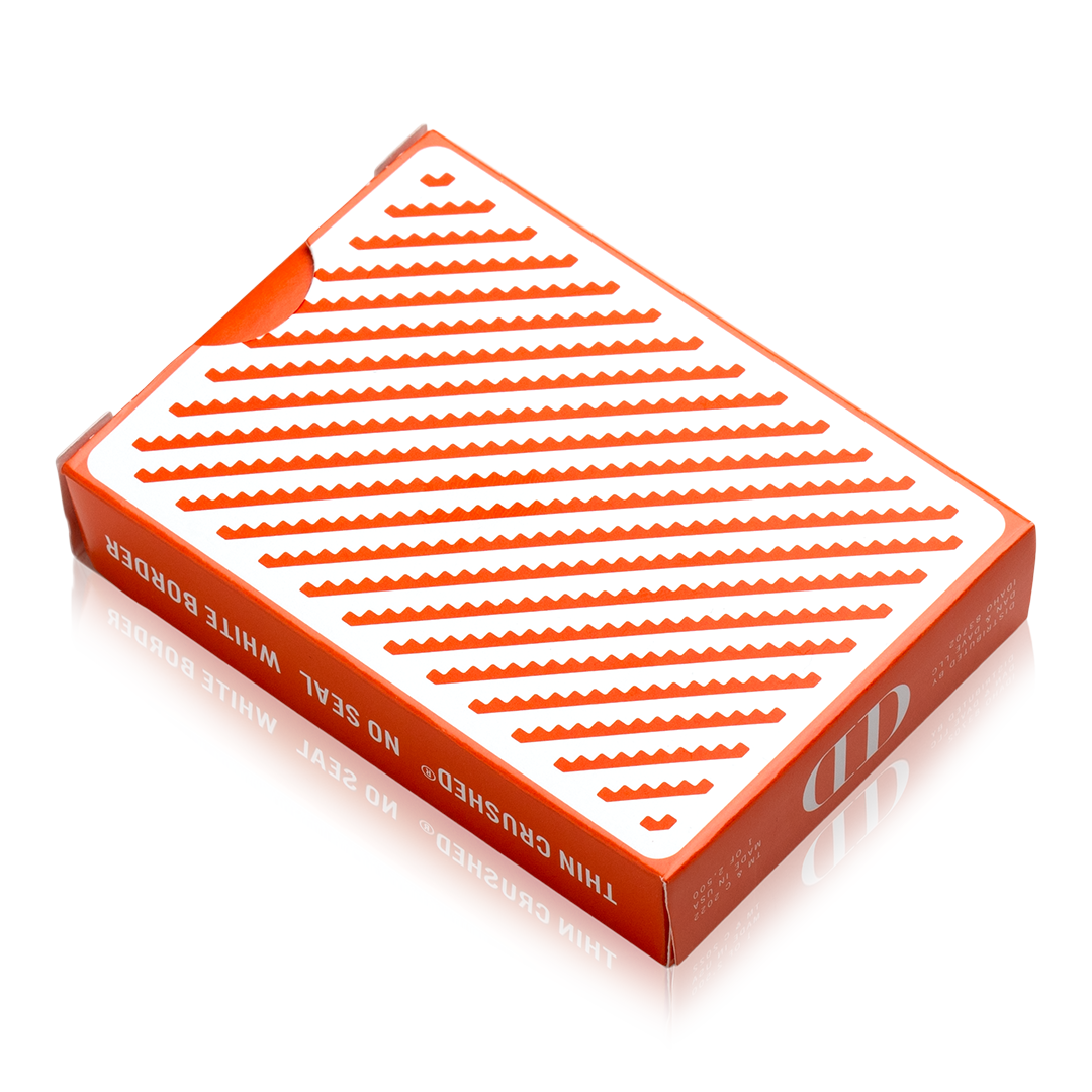 Damn Good Cards No. 5 by Dan & Dave showing the orange geometric playing card back design with repeating zigzag lines on a white background.