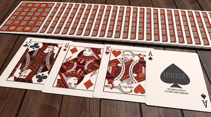 House Playing Cards spread showing the red-brick card backs with custom Jack of Clubs, Queen of Diamonds, King of Hearts and HOUSE Ace of Spades artwork