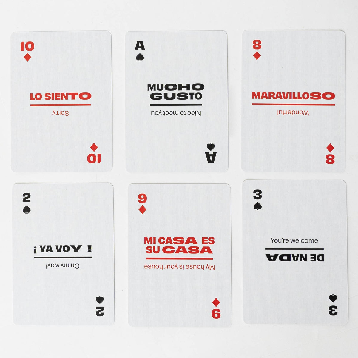 Six Lingo Spanish playing cards arranged in two rows, showing Spanish phrases with English translations, including Lo Siento, Mucho Gusto and De Nada.