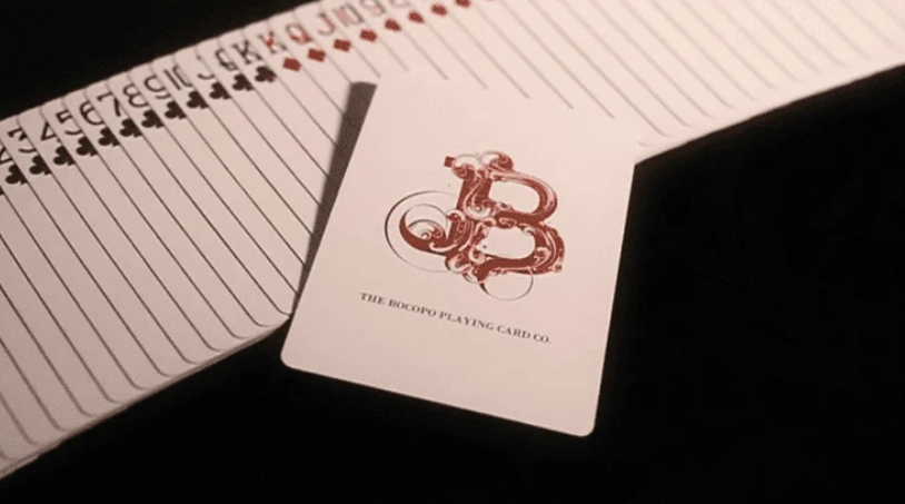 Love Promise of Vow Red Playing Cards by BOCOPO fanned out beside a custom BOCOPO Playing Card Company logo card.