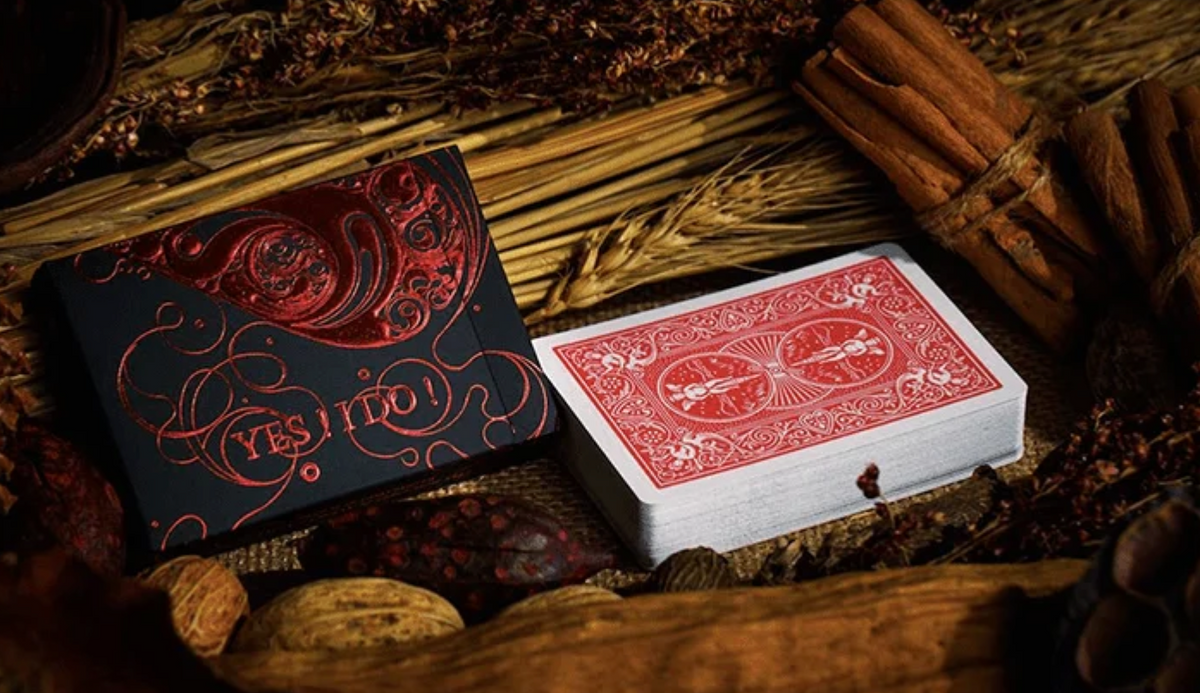 Love Promise of Vow Red Playing Cards by BOCOPO shown beside the black and red YES I DO tuck box with the red card back design visible.