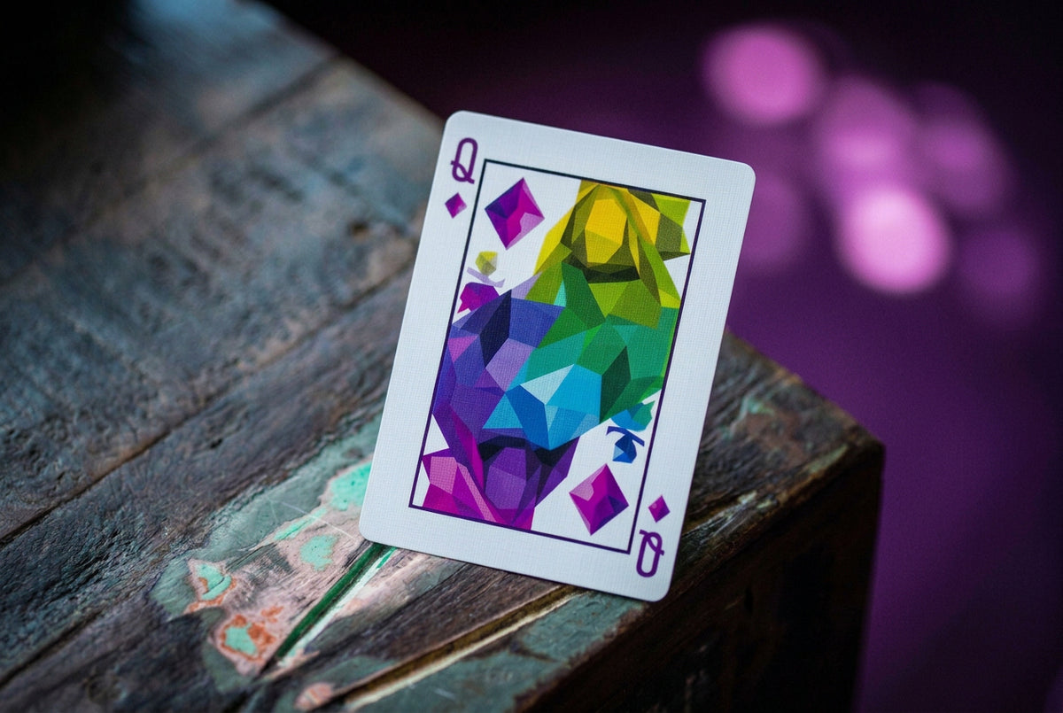 Memento Mori Playing Cards by Chris Ramsay – Queen of Diamonds featuring colourful geometric artwork in purple, blue, green and yellow.