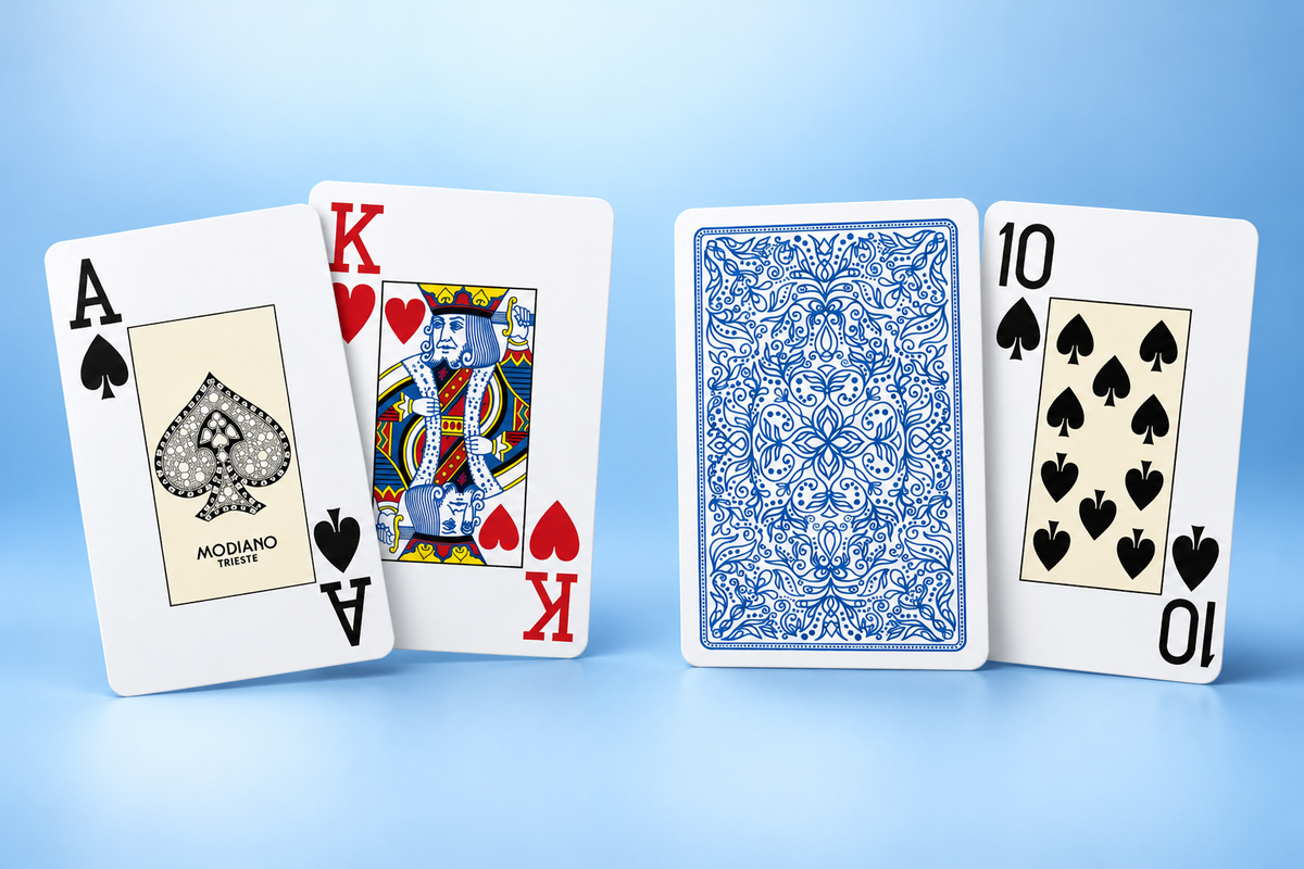 Modiano Bridge 2 Jumbo Index blue plastic playing cards showing the Ace of Spades, King of Hearts, Ten of Spades and ornate blue card back.