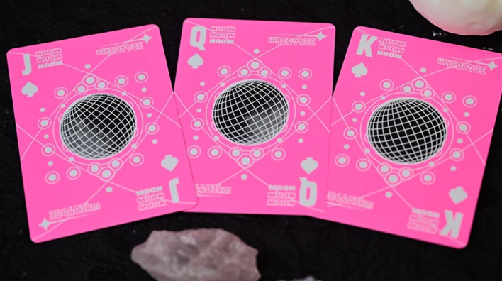 Moon Pink Standard Playing Cards by Hiddenlight showing custom Jack, Queen and King of Spades with vibrant neon pink backgrounds, black wireframe spheres, white geometric patterns and lunar-inspired artwork.