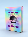 Moon White Holo Playing Cards by Hiddenlight featuring an iridescent rainbow holographic tuck box, purple MOON lettering and a central black wireframe lunar sphere design.