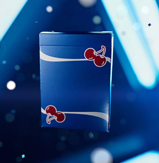 Cherry Casino Tahoe Blue Playing Cards tuck box displayed against a dramatic blue illuminated background, featuring the signature red cherries and flowing white stripes.