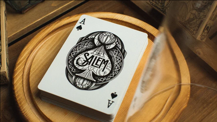 Salem Playing Cards Ace of Spades showing the ornate black SALEM artwork, displayed on a round wooden tray