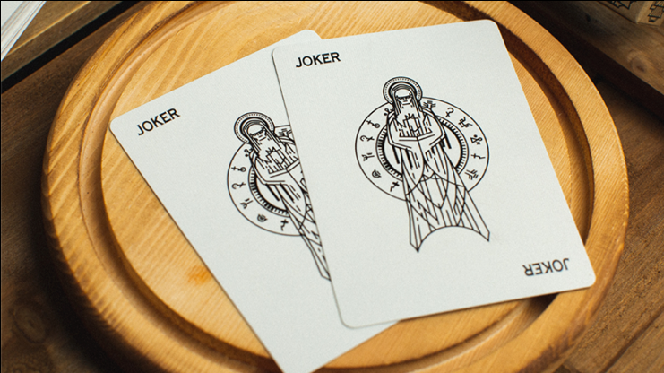Two Salem Playing Cards Jokers featuring black line-art illustrations of a cloaked figure, displayed on a round wooden tray