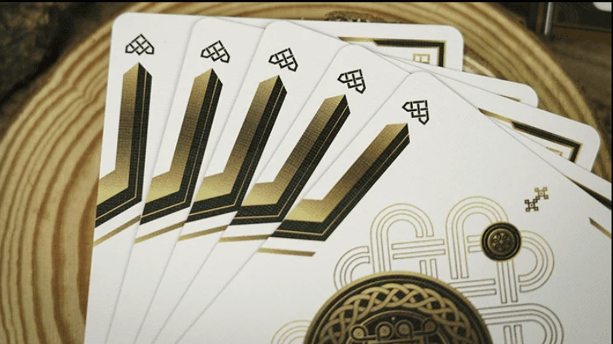 Fan of Trend Green Playing Cards by TCC showing the minimalist white card faces with black and gold geometric corner designs and decorative medallion artwork