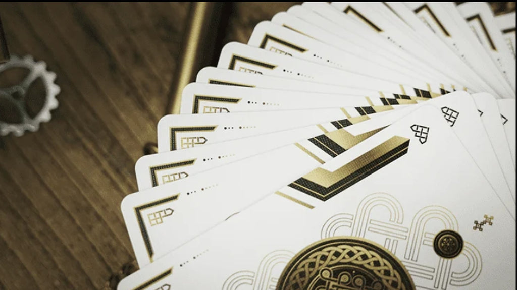 Trend Green Playing Cards by TCC spread in a wide cardistry fan, showing the minimalist white faces with black and gold geometric detailing