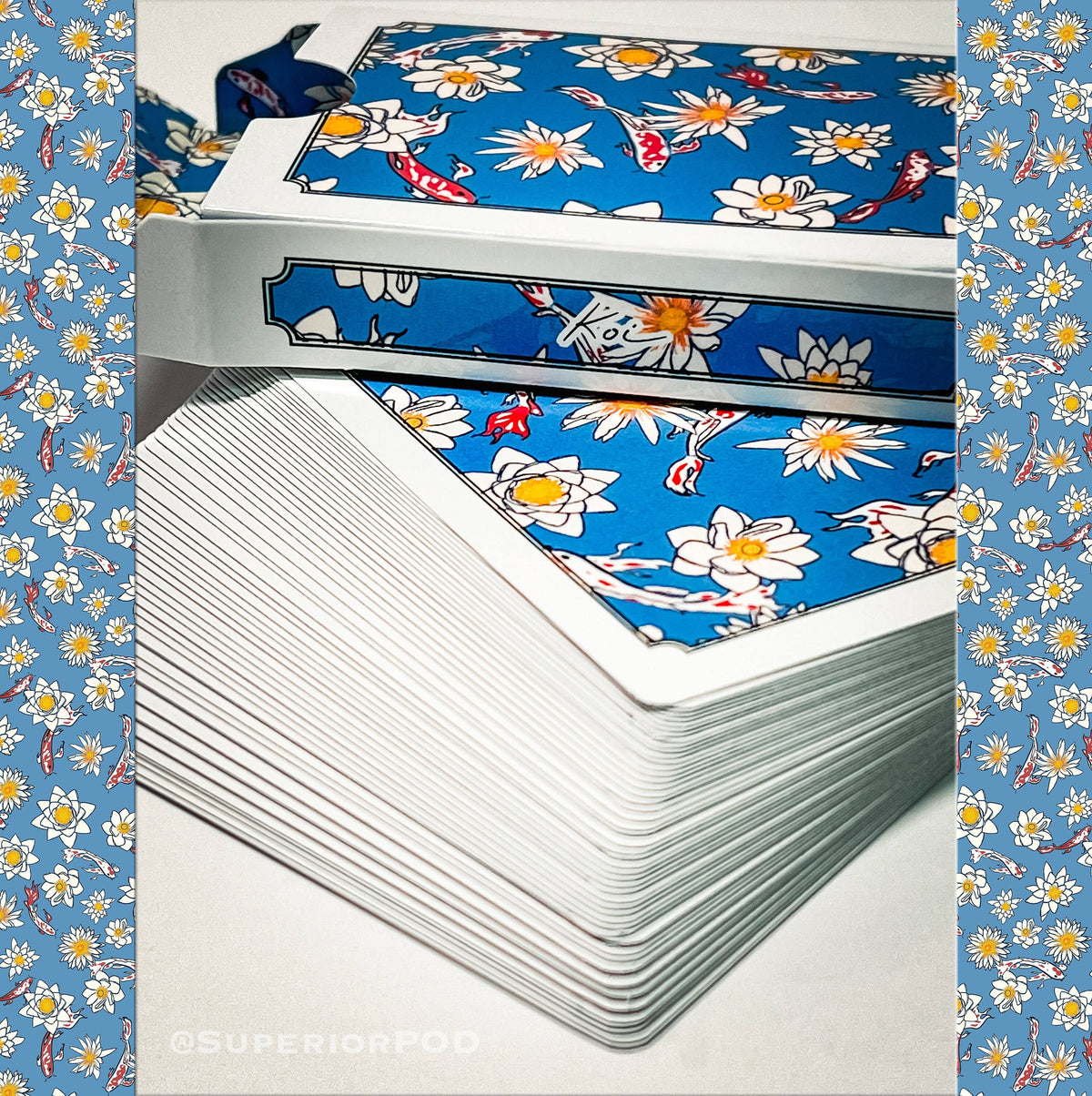 Koi Fish Playing Cards by Superior Print on Demand showing a stacked deck with blue koi fish and white lotus artwork