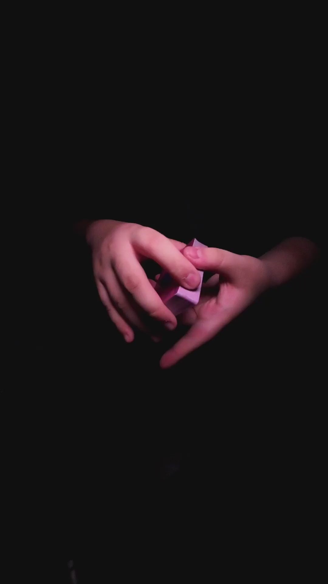 Moon Noon Holo Pink Playing Cards cardistry demonstration showcasing smooth card flourishes, intricate hand movements and vibrant holographic pink playing cards with rainbow foil detailing against a black background.
